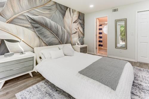 a bedroom with a large bed and a mirror at Florida Fun! Family Condo with Pool, 8 Mi to WDW in Kissimmee