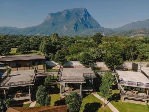 an aerial view of a house with a mountain in the background at Black Bears Resort & Onsen in Ban Thung Lakhon
