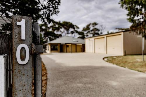 a house with a number on a driveway at Total ~ Allure ~ in Bicheno