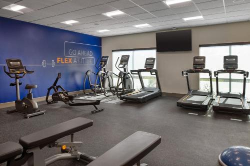 a gym with several treadmills and exercise bikes at Holiday Inn Express & Suites Fresno Airport by IHG in Fresno