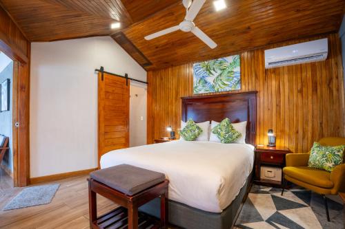 a bedroom with a bed and a chair at Camino Verde B&B Monteverde Costa Rica in Monteverde Costa Rica