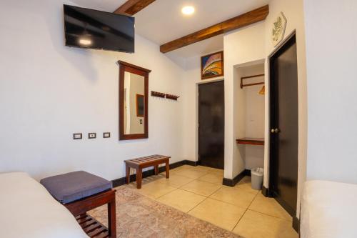 a room with a mirror and a tv on the wall at Camino Verde B&B Monteverde Costa Rica in Monteverde Costa Rica
