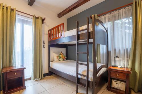 a bedroom with two bunk beds and a window at Camino Verde B&B Monteverde Costa Rica in Monteverde Costa Rica