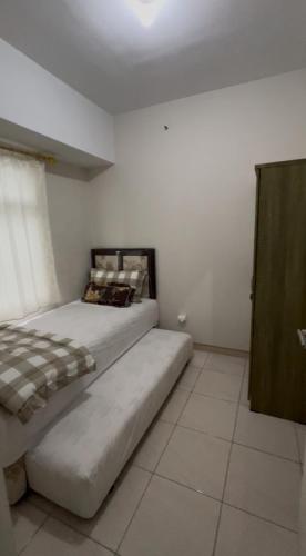 a bedroom with a bed in a room at A Simple stay at SpringLake Apartment, Bekasi in Rawabugel