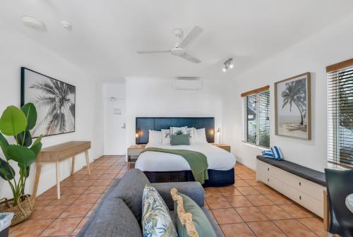 a hotel room with a bed and a couch at Ocean Outlook - Absolute Beachfront Studio in Palm Cove