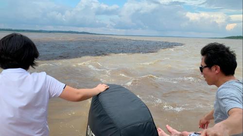 two people standing on the beach with a kite at Amazon Private Tours Jungle Lodge in Manacapuru