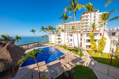 an aerial view of a resort with a swimming pool and the ocean at Vista Vallarta All Suites On The Beach in Bucerías