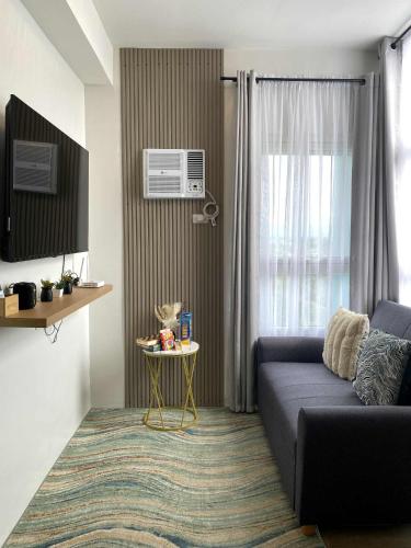 a living room with a couch and a table at H4R1 Luxe Haven in Bacolod