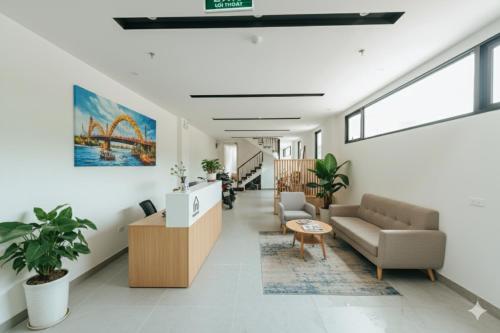 a living room with a couch and a table at Crescendo Limitless Style in Hanoi