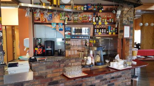 a bar in a restaurant with a brick wall at Konse Motel and Caravan Camping in Pärnu
