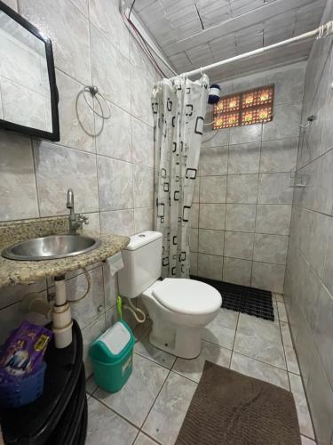 a bathroom with a toilet and a sink and a shower at Casa chalé em Tamandaré in Tamandaré