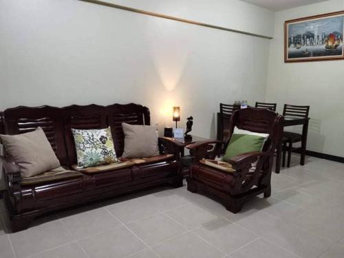 a living room with a couch and a chair at Asteria Residences Paranaque Sucat 2 Bedroom in Sampong