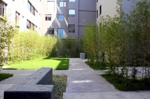 a garden with a bench in front of a building at Yiho Hotel Xiamen Huli in Xiamen