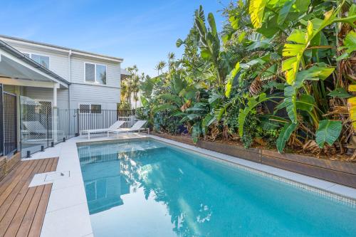 a swimming pool in front of a house at Bridgeport pet-friendly Pool Getaway in Margate