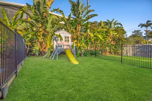 a backyard with a playground with a slide at Bridgeport pet-friendly Pool Getaway in Margate