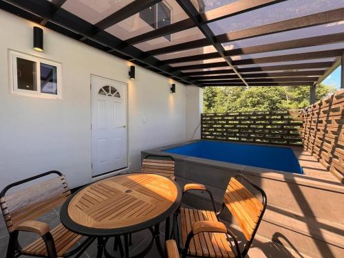 a patio with a ping pong table and chairs at Gangneung Stay There in Ŭmji-mal