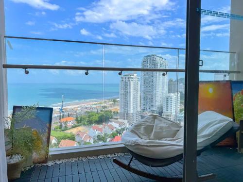 a balcony with a bed and a view of the city at Sea Breeze Apartment - The Song Căn Hộ Du Lịch Biển Vũng Tàu in Vung Tau