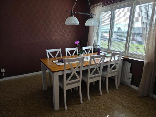 a dining room table and chairs in a room with a window at Annexet 1 & 2 in Fränsta