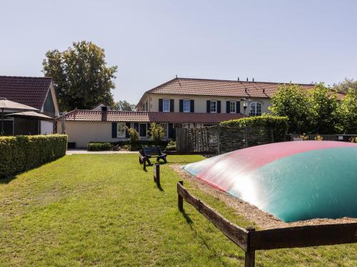 a swimming pool in a yard next to a house at Brabant Retreat Close to Tilburg in Westelbeers