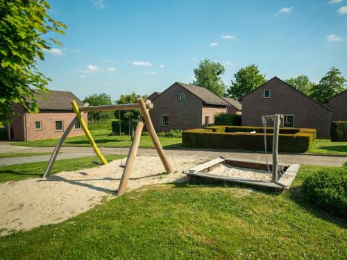 a swing set in the grass in a yard at Charming Holiday Home Near Vijlen in Vijlen