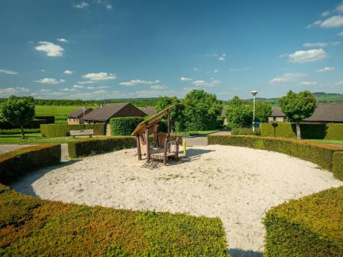 a playground in a park with a sandbox at Charming Holiday Home Near Vijlen in Vijlen