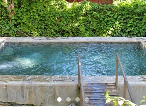 a pool of water with a staircase in it at Villabadlou Ti-Colibri in Trois-Rivières