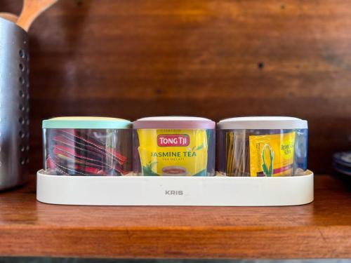 three canisters of food sitting on a shelf at 1 Br Ruang Tenang Ubud, Great Location in Ubud