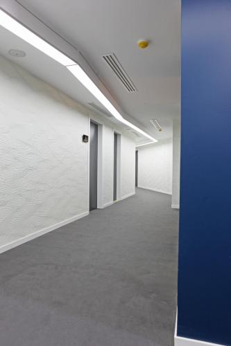 an empty room with white walls and a blue door at Aleph Boutique Hotel in Jbeil