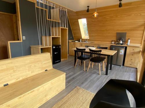 une cuisine et une salle à manger avec une table et des chaises dans l'établissement OUTSCAPE l Hermosa Cabaña en Parque Nacional Cerro Castillo, à Villa Cerro Castillo