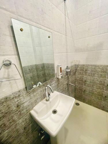 a bathroom with a sink and a mirror at Hasrat Residency in Jagādhri