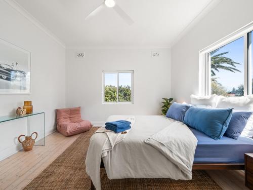 a white room with a bed and a window at The Fletcher Bondi in Sydney