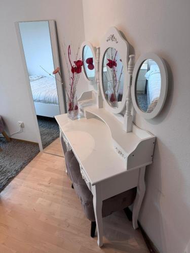 a white dressing table with two mirrors on it at EBE-Connect in Ebersberg