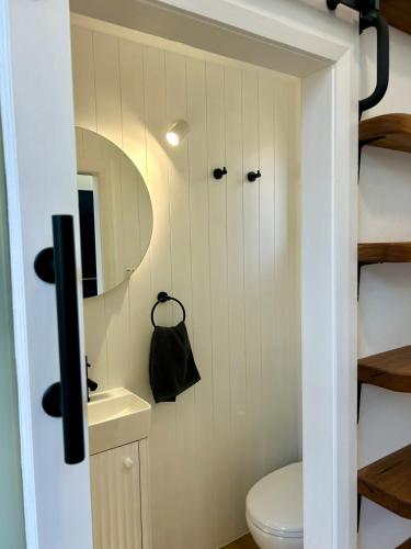 a small bathroom with a toilet in a tiny house at Wollongong Tiny Home