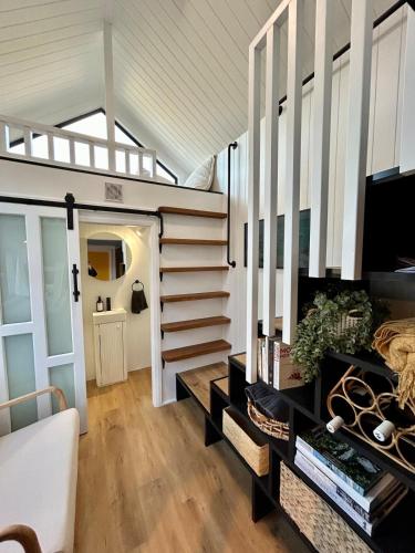 a room with a spiral staircase in a house at Wollongong Tiny Home