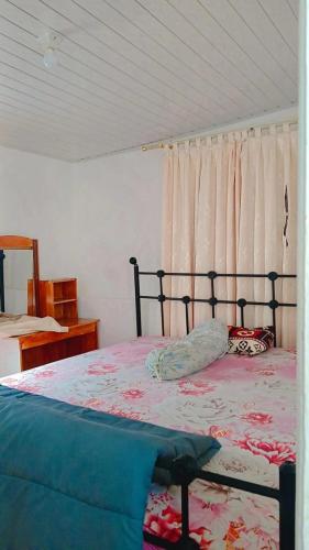 a bedroom with a bed with a canopy and curtains at Villa Highland No 9 Berastagi View in Berastagi
