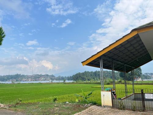 a gas station with a field in the background at Puni Anjung Homestay in Panjalu