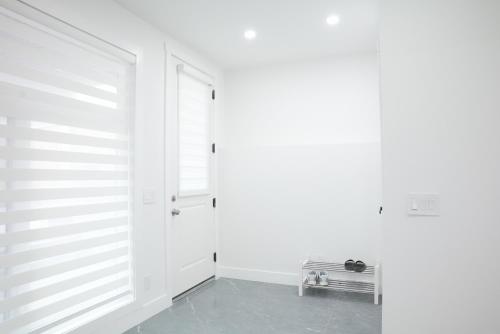 a room with a white wall and a door at New Luxury Walkout Suite Near University-BY ROOM in Calgary