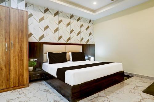 a bedroom with a large bed in a room at Hotel O The Skies in Juhi Bari