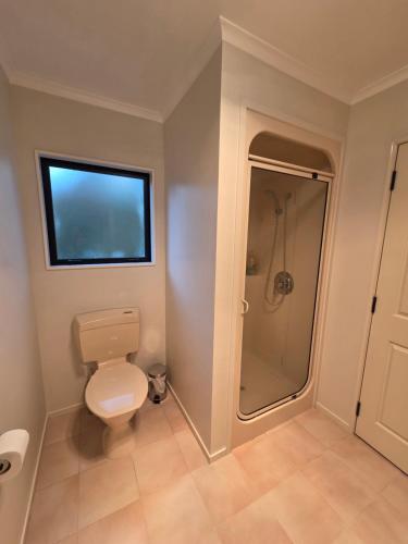 a bathroom with a toilet and a shower at Rooms in an Epsom House in Auckland
