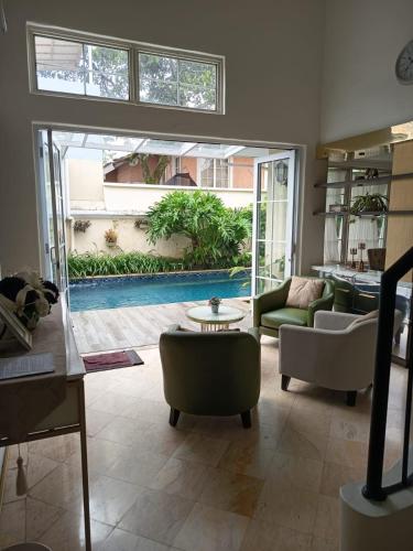 a living room with a view of a pool at Omah Kumpul Sentul in Bogor