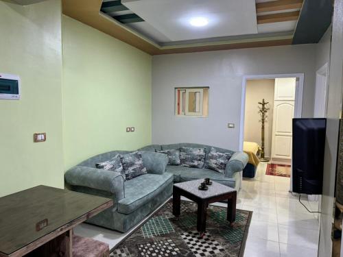 a living room with a couch and a tv at شقة للايجار in Sharm El Sheikh