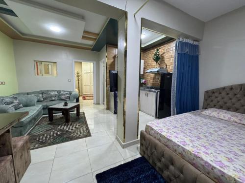 a bedroom with a bed and a living room at شقة للايجار in Sharm El Sheikh