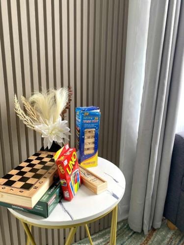 a table with books and a chess board on it at H4R1 Luxe Haven in Bacolod