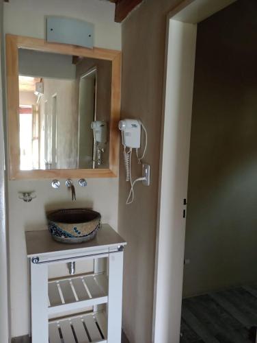 a bathroom with a sink and a mirror at La Chacra Hotel Campo y Spa in San Pedro