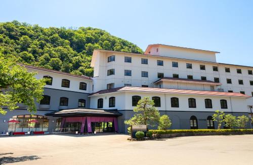 a large white building with a tent in front of it at Yamanaka Onsen Kajikaso - Opening in 1st, Aug 2025 in Kaga