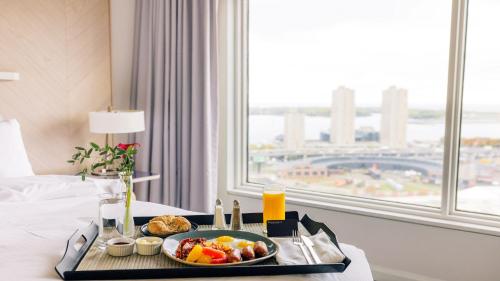 a tray of food on a bed in a hotel room at InterContinental Toronto Centre by IHG in Toronto
