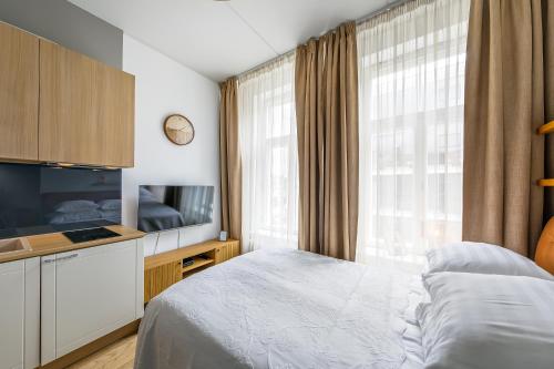 a bedroom with a bed and a large window at Stylish Apartment near Old Town in Tallinn