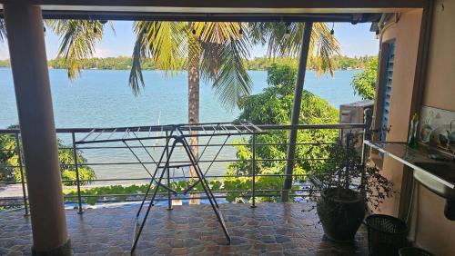 a room with a view of the water from a balcony at Lagoon Breeze Resort in Batticaloa