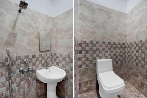 a bathroom with a toilet and a sink at Hotel O Vrindavan Gardan & Hotel in Prayagraj