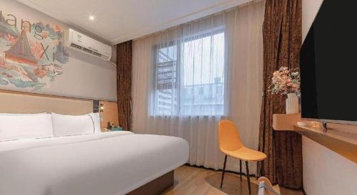 a hotel room with a large bed and a window at City Comfort Inn Liuzhou High-speed Railway Station in Liuzhou